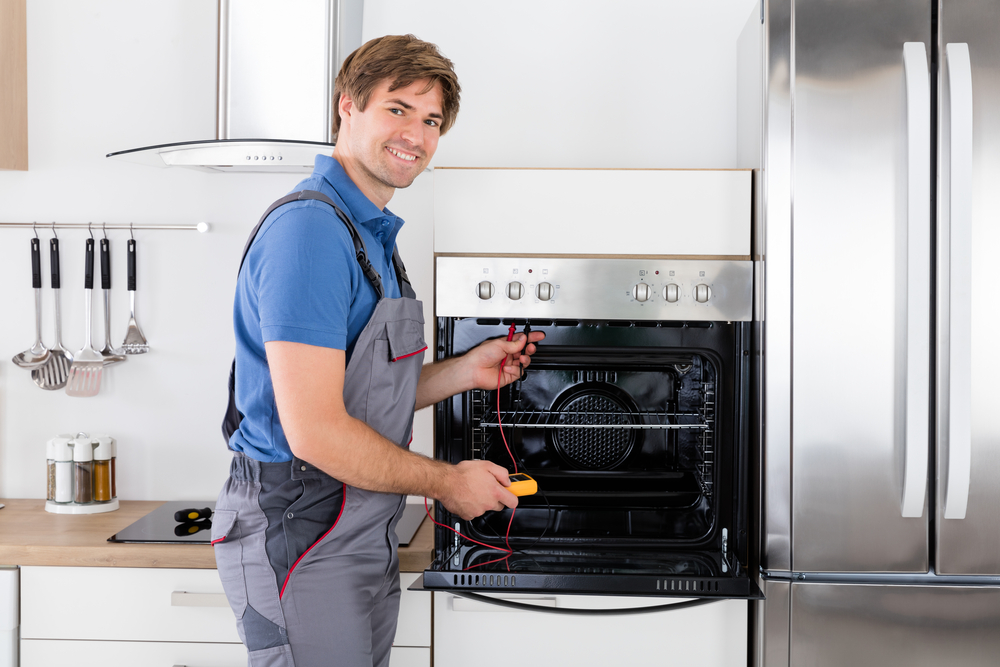 Male Technician Checking Oven appliance repair