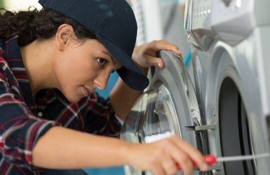 woman fixing a dryer