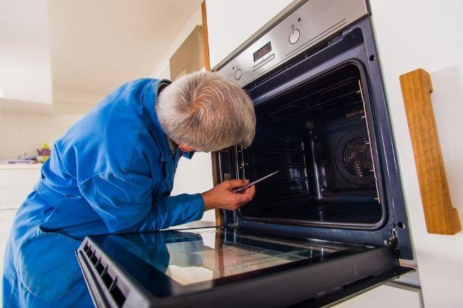 man fixing oven repair | appliance installation