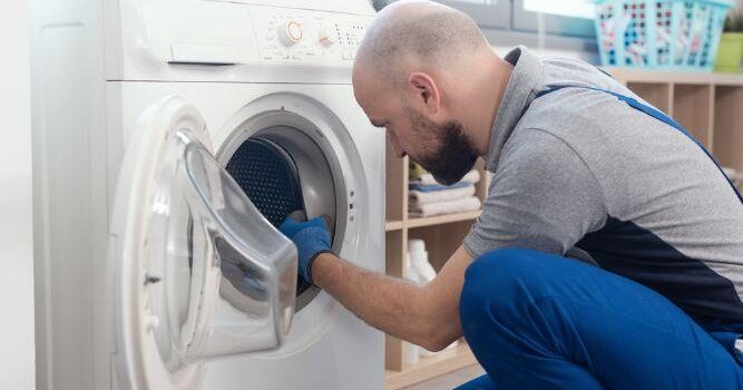 man working inside the washing machine
